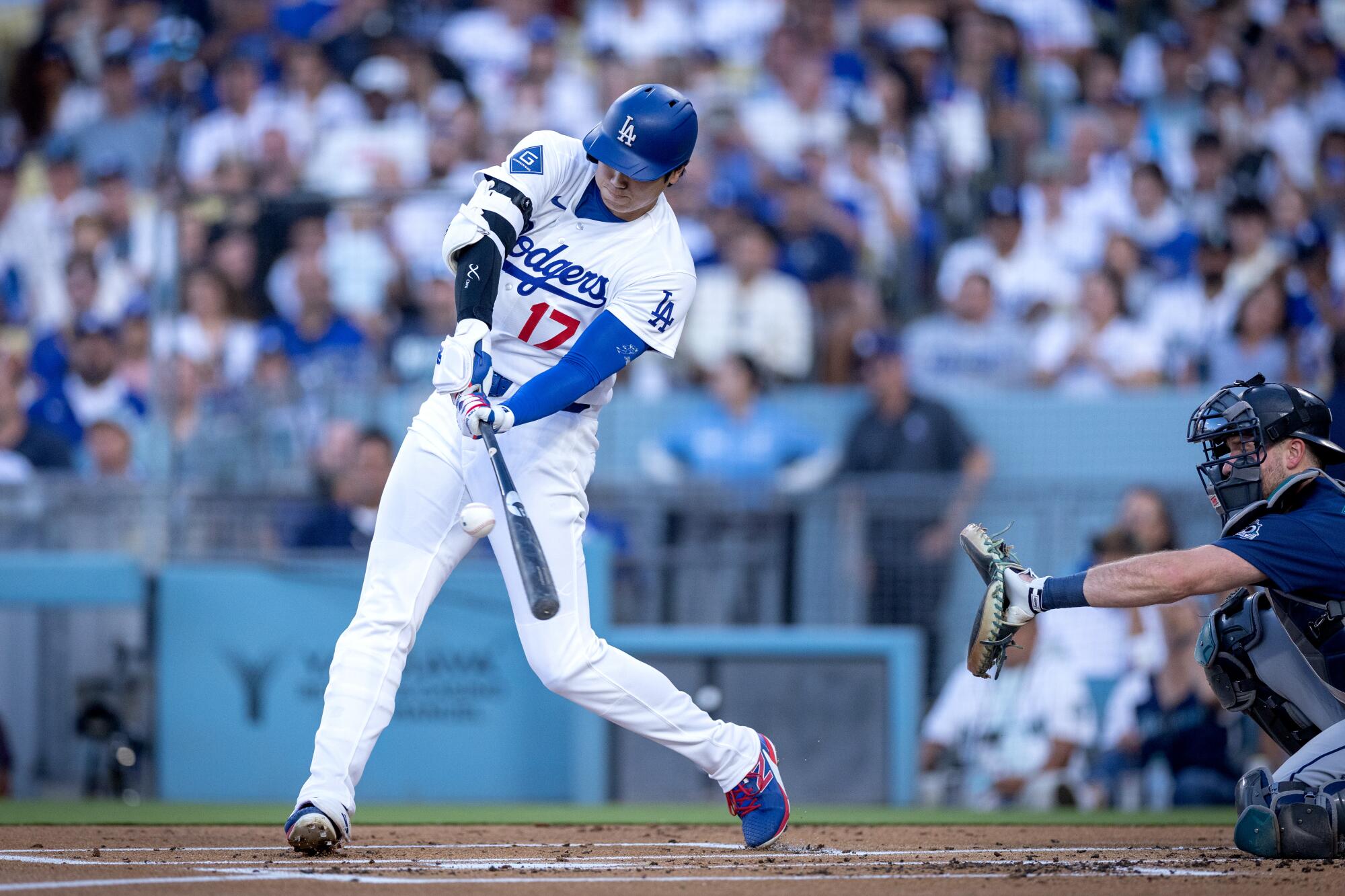 Dodgers star Shohei Ohtani hits a home run against the Seattle Mariners at Dodger Stadium on Tuesday.