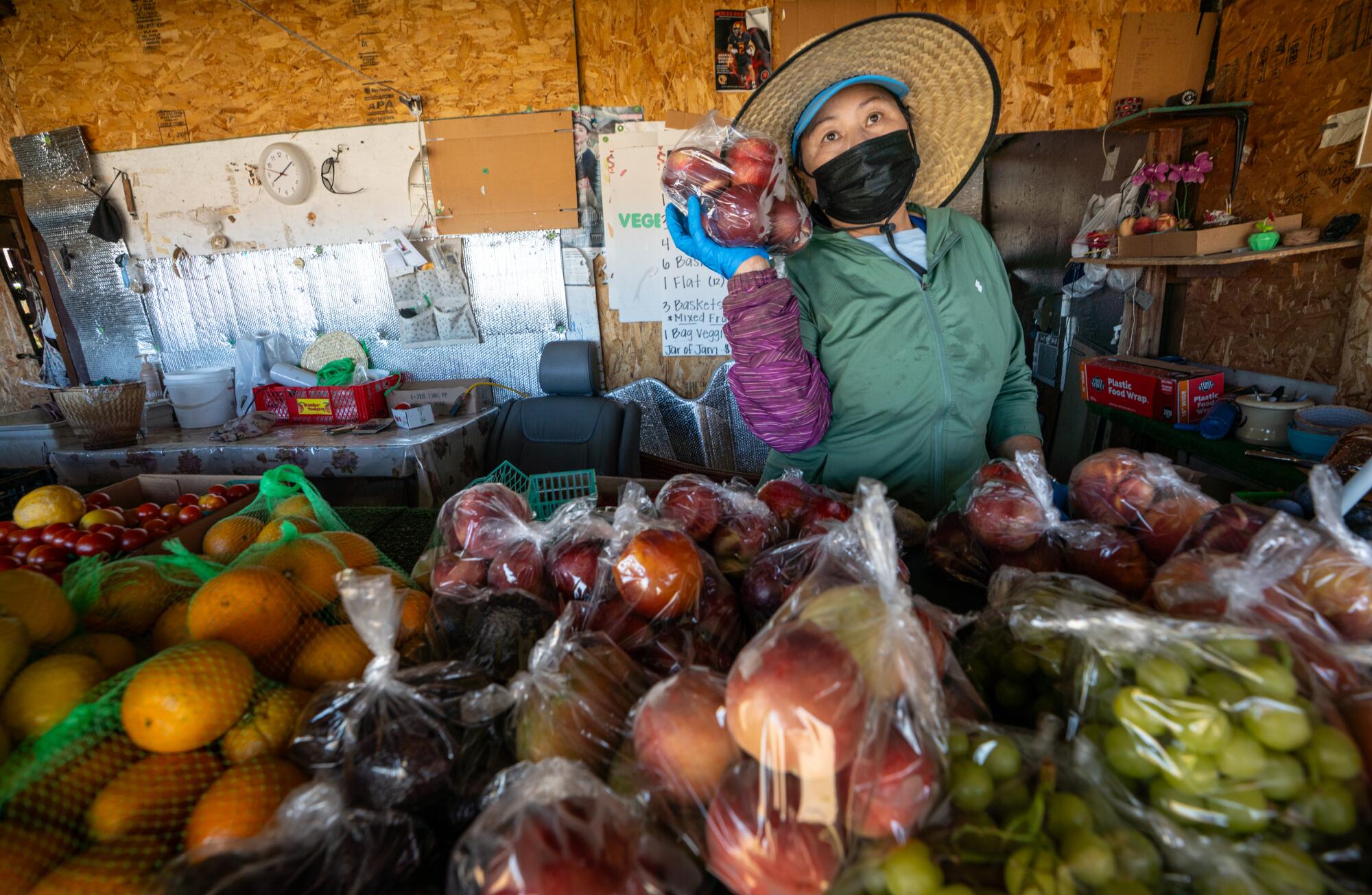 A woman sells fruits and vegetables.