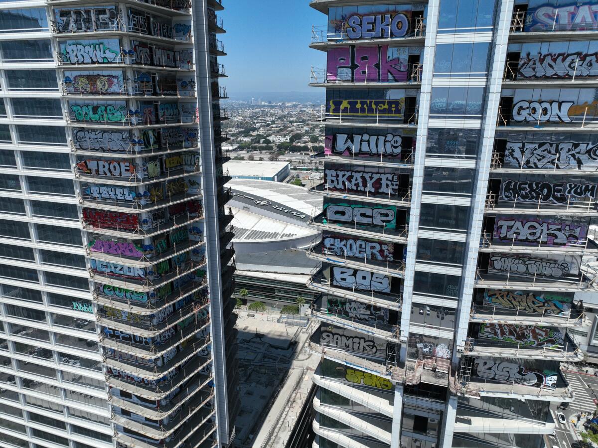 An aerial view of graffiti covering Oceanwide Plaza with Crypto.com Arena in the background.