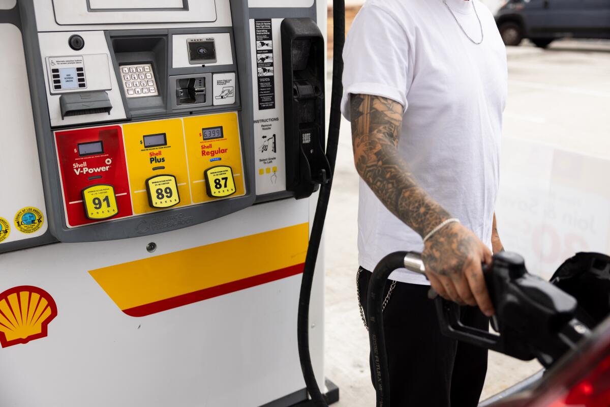 A driver gets gas at a Shell gas station in Long Beach