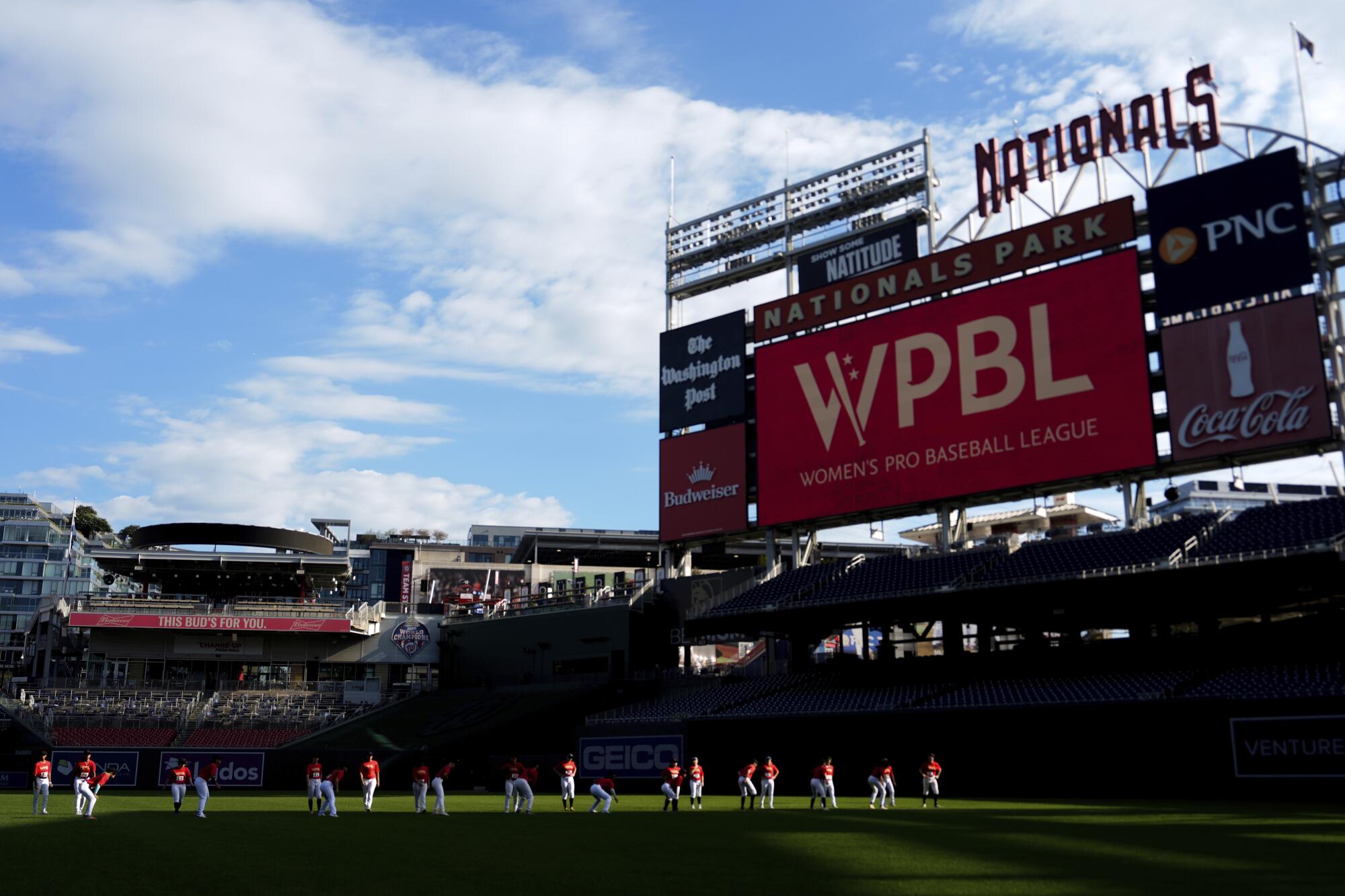 Players warm up before a game on the fourth day of tryouts for the Women's Professional Baseball League in August 2025.