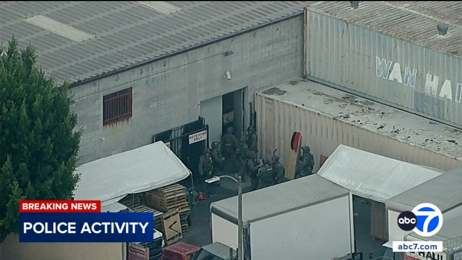 SWAT officers swarm South Los Angeles warehouse after serving search warrant