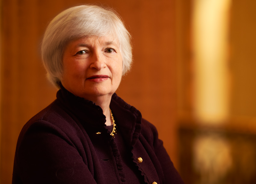 woman standing wearing black jacket with short white hair