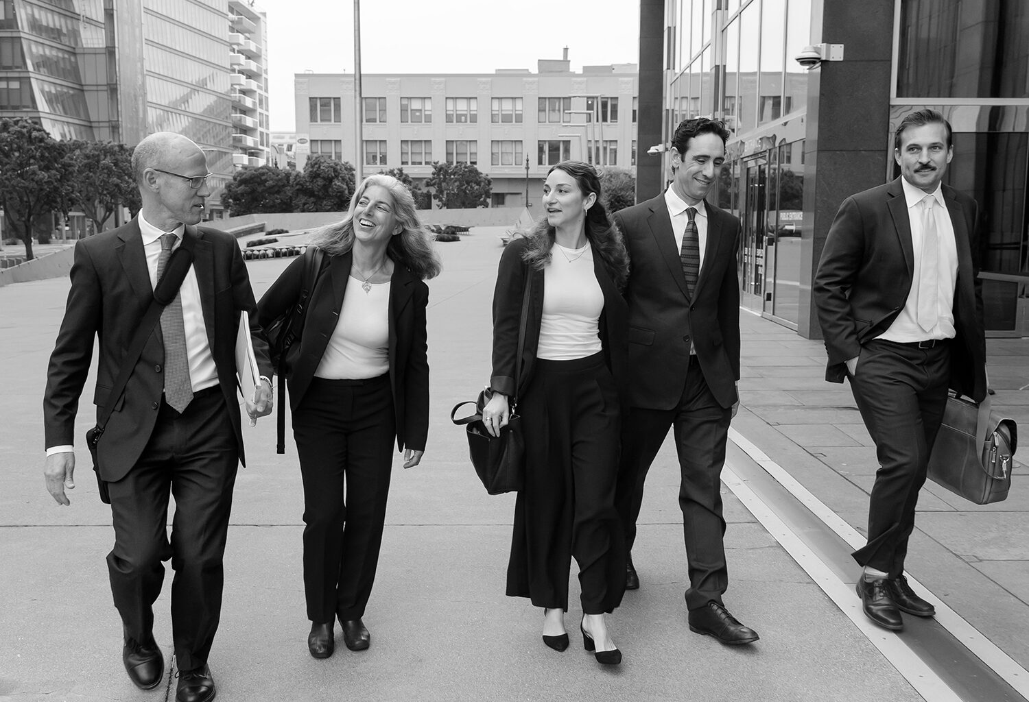 Group of five walking outside courthouse