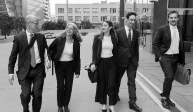 Group of five walking outside courthouse
