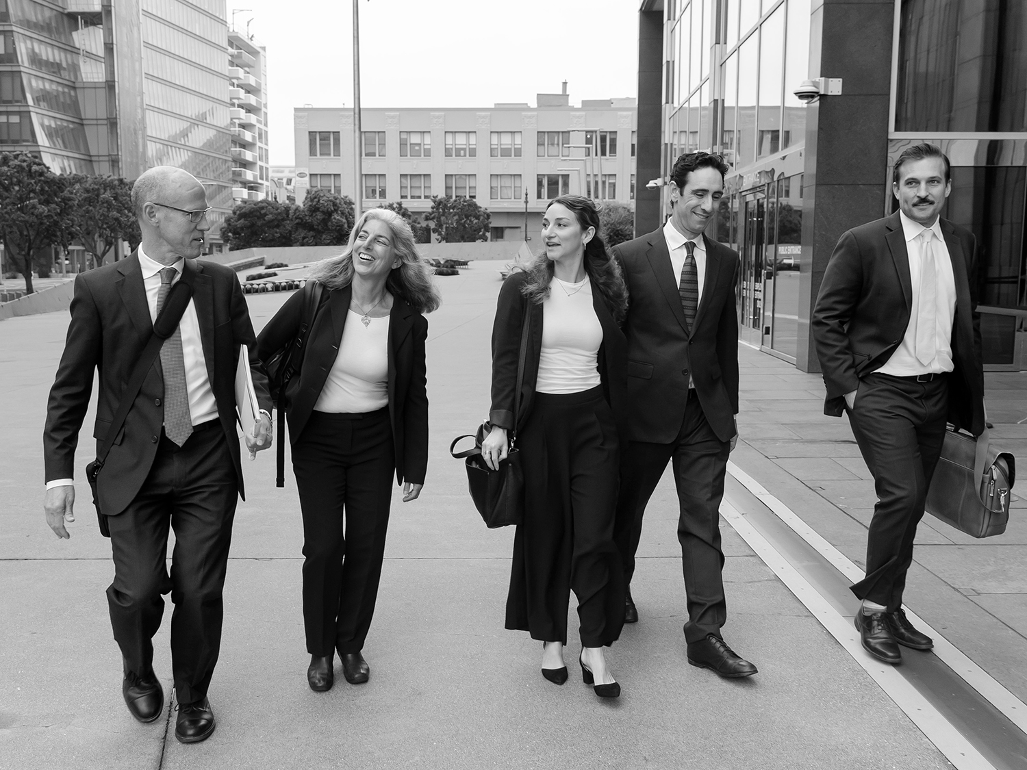 Group of five walking outside courthouse