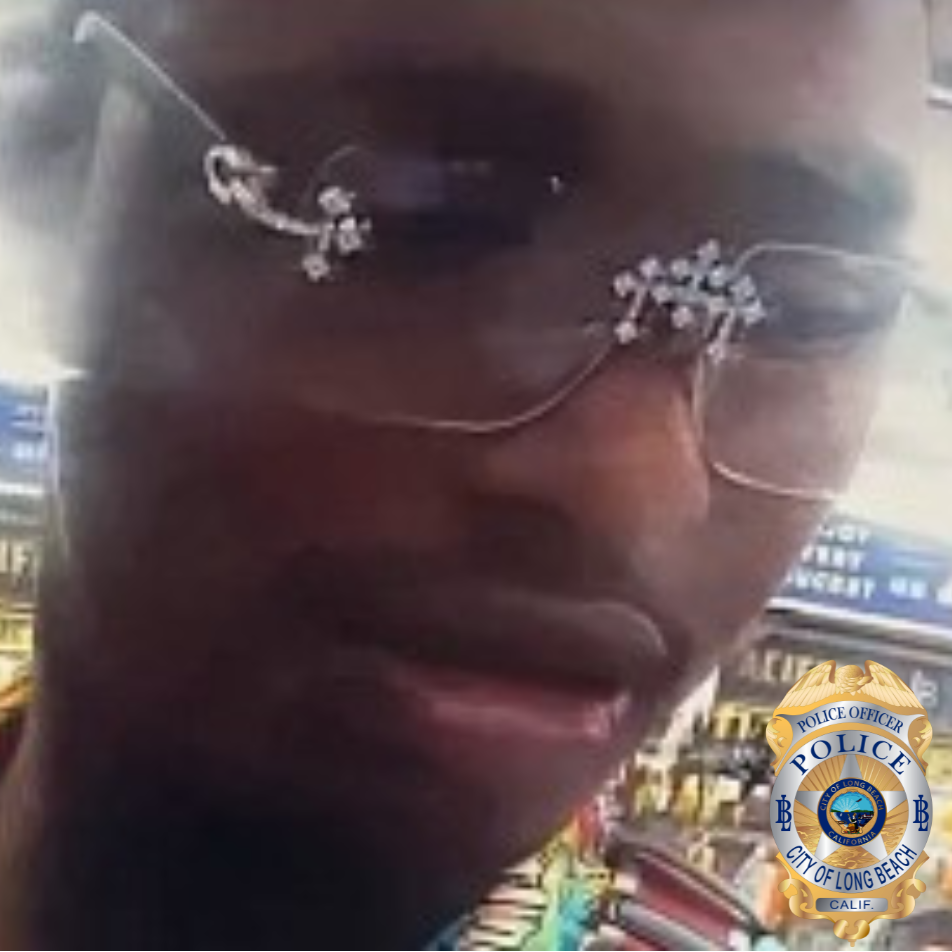 Surveillance photo of a the face of a man wearing frameless eyeglasses that have diamond accents on the hinges and the bridge.