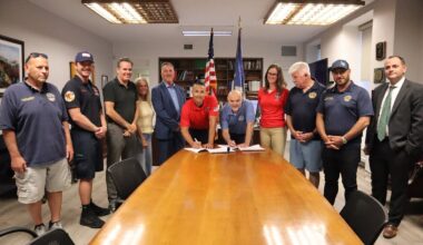 IAFF Local 287 President Sam Pinto, center left, and City Manager Daniel Creighton signed the long-awaited contract, surrounded by the City Council and members of the Long Beach Fire Department.