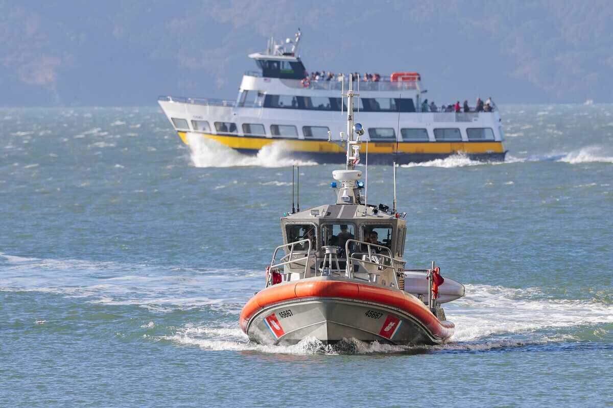 A U.S. Coast Guard vessel enters Gashouse Cove in San Francisco on Tuesday, July 14, 2026, as crews search for passengers after the vessel Volare sank west of Alcatraz. Authorities have recovered the bodies of Clifford Boisa, of Sutter County, and Tondra Madruga, of Folsom, after 16 other passengers were rescued.