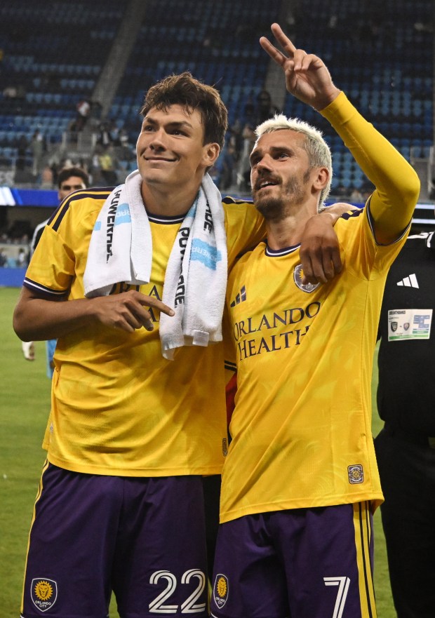 Justin Ellis #22 and Antoine Griezmann #7 of Orlando City celebrate after winning during the MLS match between San Jose Earthquakes and Orlando City SC at PayPal Park on Wednesday in San Jose, California. (Brandon Vallance/Getty Images)