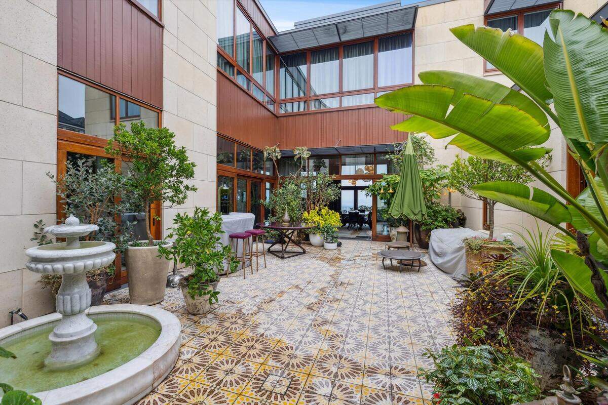 The grounds include an English-style garden and a courtyard with mature citrus trees, including lemons and limes.