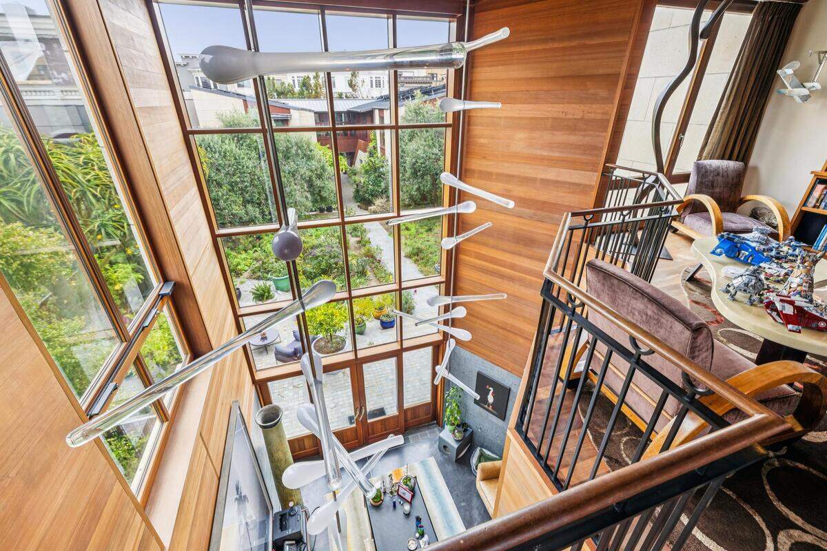 The listing describes the home as designed around a private courtyard, with custom mahogany window frames crafted in Italy.
