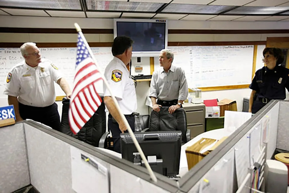 President George W. Bush speaks with U.S. Forest Service and public safety personnel in Redding during a visit to the wildfire command center on July 17, 2008. Bush was briefed on the wildfire damage in Northern California.