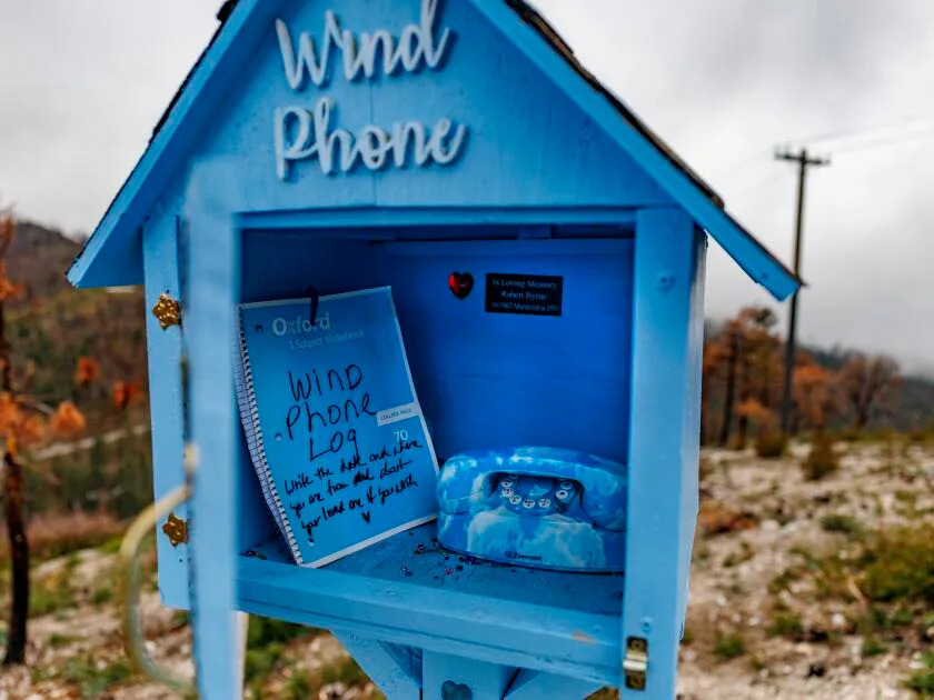 A notebook stands inside the wind phone structure.