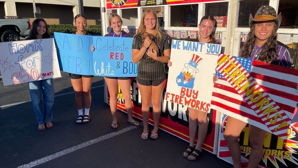 Bakersfield Bandits Softball League pose with their creative posters, as the TNT firework stand officially opens. PHOTO: KBAK