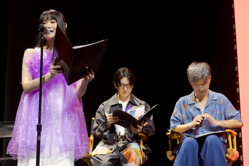 Voice actors speaking at a panel