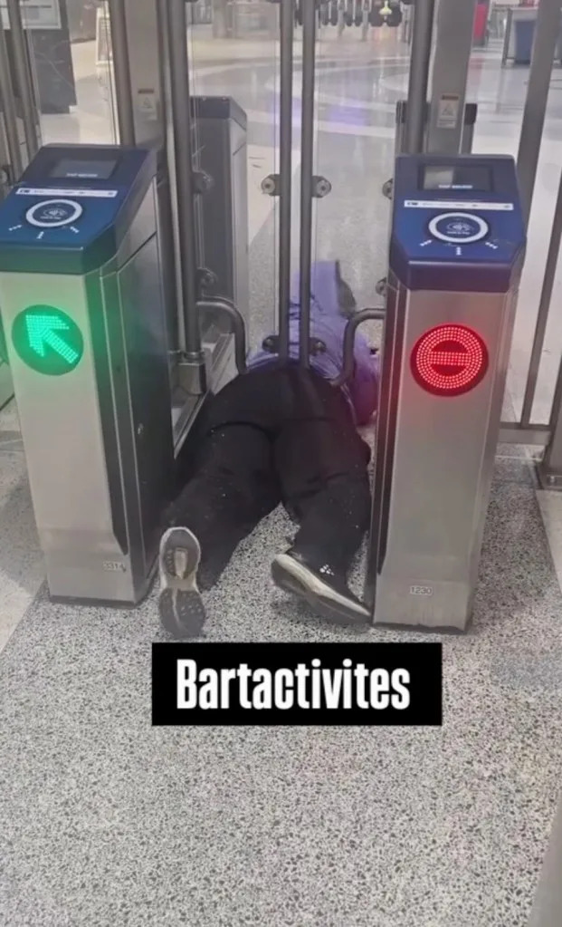 A person stuck under a BART entry gate. Instagram/@bartactivities