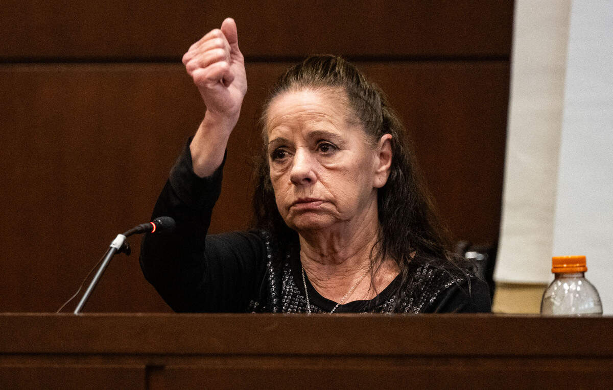 Victim Kimberlee Guillory makes a downward stabbing motion, describing the knife attack that ripped open the tent where she living in Davis and sent her to the hospital, as she testifies on Wednesday, May 7, 2025, during the trial of Carlos Reales Dominguez in Yolo Superior Court in Woodland.