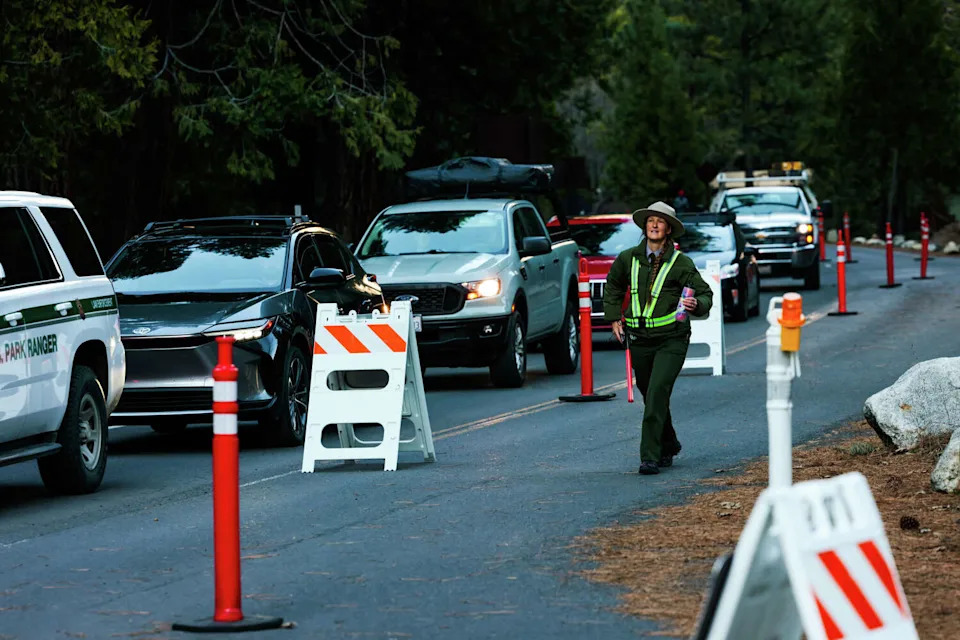 National park ranger Kate Trust walks on a lane used for pedestrians as vehicles use another at Yosemite National Park on Friday, Feb. 13. Yosemite is entering its first summer in years without broad vehicle reservations, and two California senators say early crowding is a warning sign. Sens. Alex Padilla and Adam Schiff asked federal park leaders whether they would reinstate reservations if peak-season traffic becomes too burdensome. (Yalonda M. James/S.F. Chronicle)
