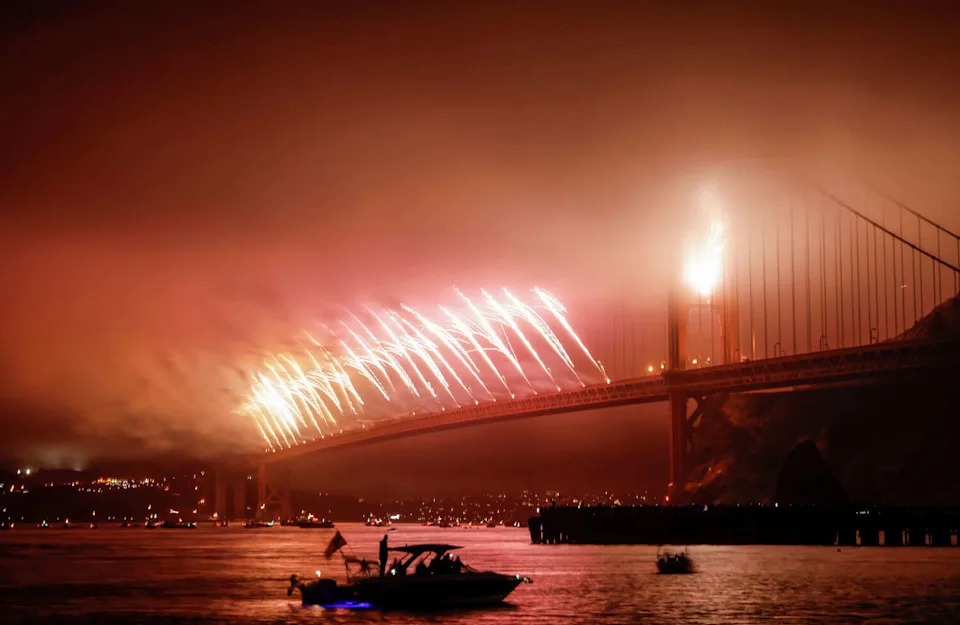 Bursts of color surround the Golden Gate Bridge during Saturday night's Fourth of July celebration, which was marred by fog. (Carlos Avila Gonzalez/S.F. Chronicle)