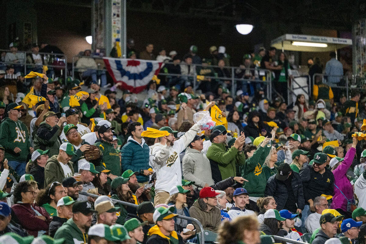 Fans raise their rally towels during the first Major League Baseball game at Sutter Health Park in West Sacramento on Monday, March 31, 2025.