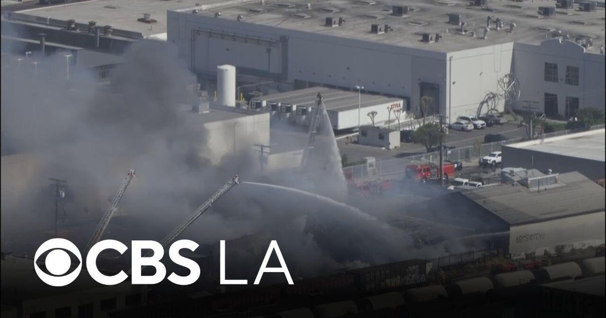 LA County firefighters extinguish flames burning Vernon warehouse