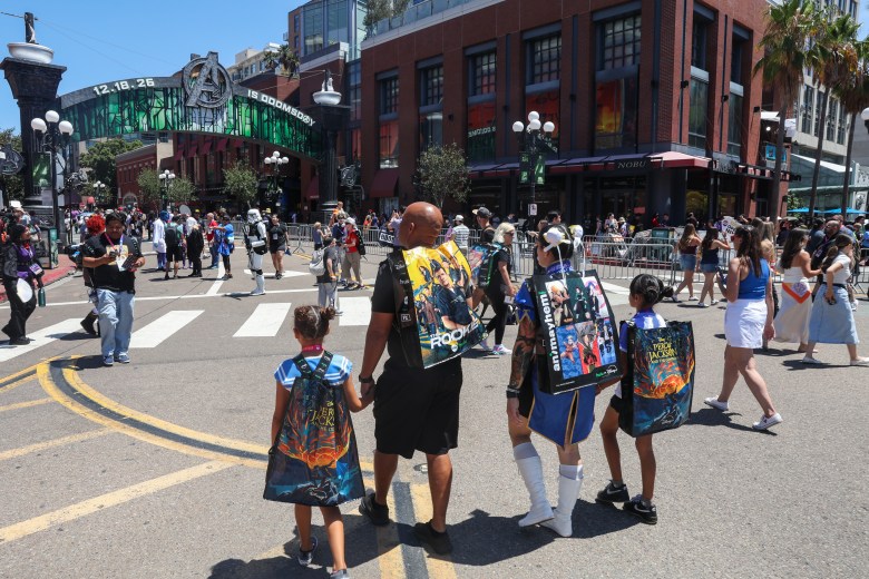 Family holds hand below sign