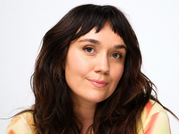 a woman with wavy dark hair