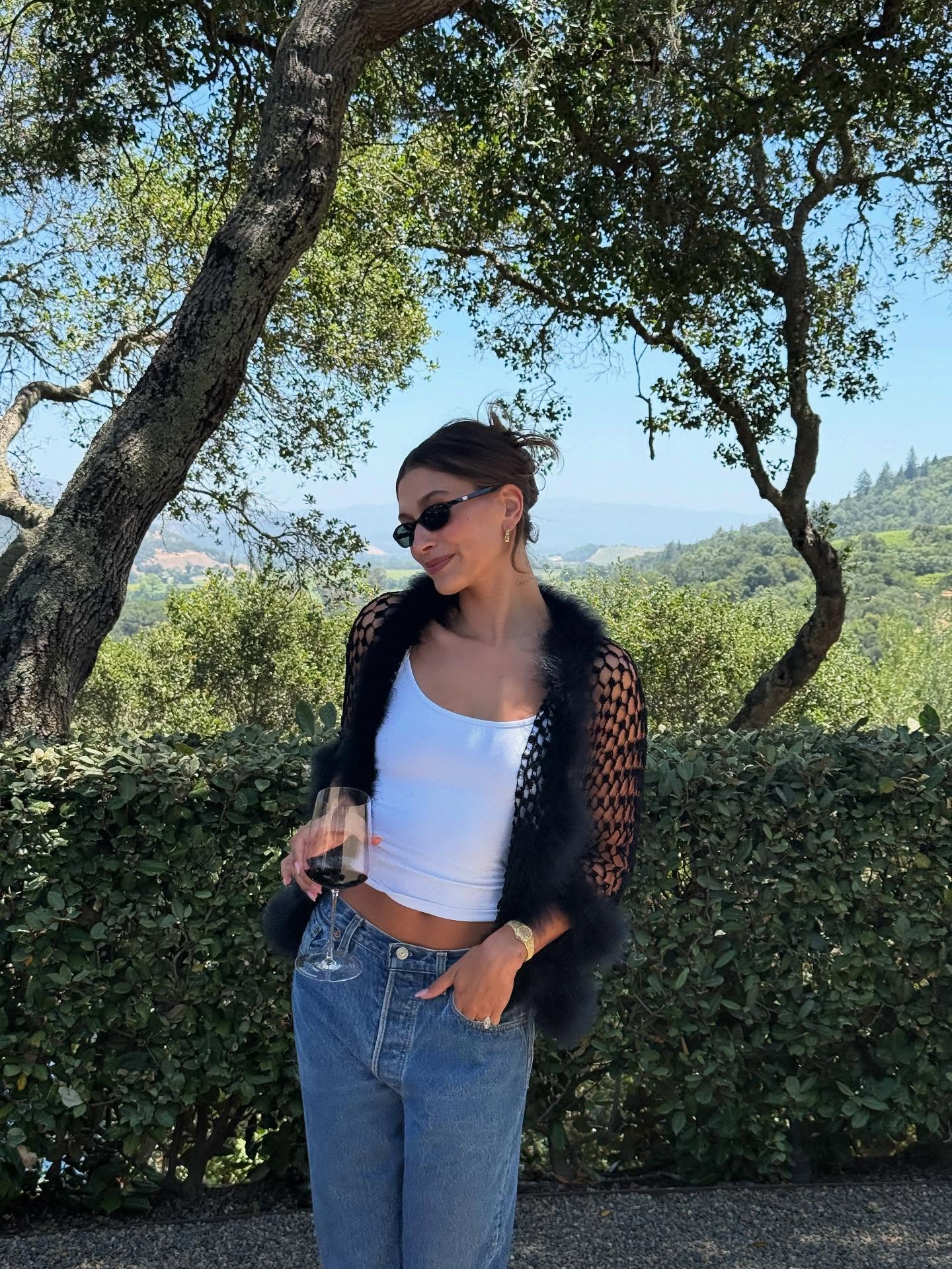 Hailey in statement jacket, white cami and jeans
