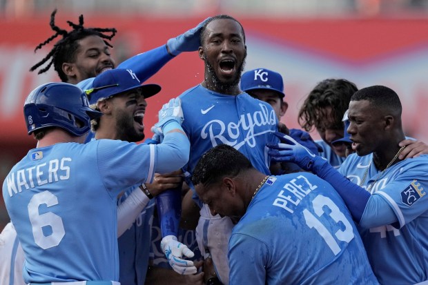 Kansas City Royals' Samad Taylor, center, celebrates with teammates after hitting a single to drive in the winning run during the ninth inning of a baseball game against the Los Angeles Angels Saturday, June 17, 2023, in Kansas City, Mo. The Royals won 10-9. (AP Photo/Charlie Riedel)