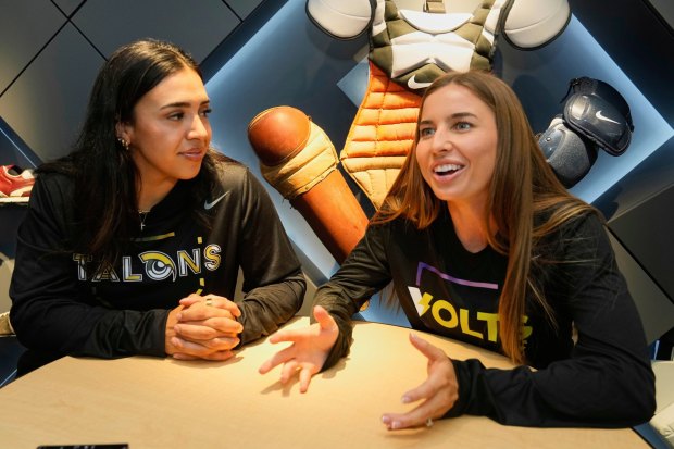 FILE - Athletes Unlimited Softball League players Sharlize Palacios, left, of the Talons, and Sis Bates of the Bolts, are interviewed at Major League Baseball's headquarters in New York, Thursday, May 29, 2025. (AP Photo/Richard Drew, File