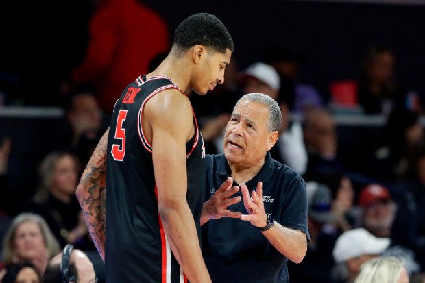 Houston head coach Kelvin Sampon, right, talks with center Chris Cenac Jr. (5) at the bench during the second half of an NCAA college basketball game against Arizona State Sunday, Jan. 18, 2026, in Houston. (AP Photo/Michael Wyke)