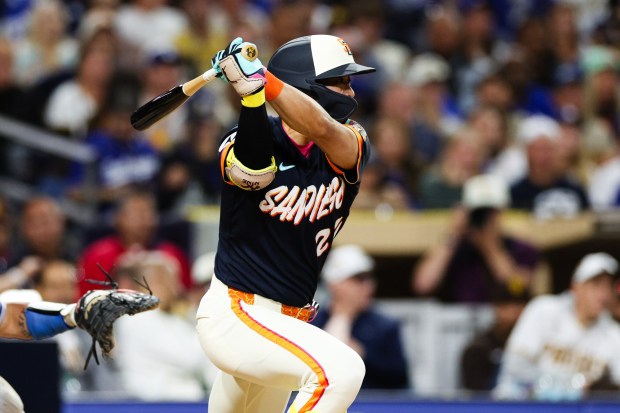 The San Diego Padres' Sung-Mun Song hits two-run single during the eighth inning of a game against the Dodgers on Friday, June 26, 2026, in San Diego. (AP Photo/Derrick Tuskan)