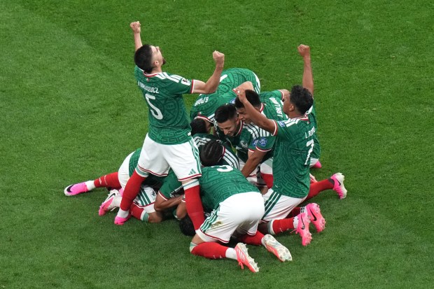 Mexico's Raul Jimenez celebrates with teammates after scoring against Ecuador.