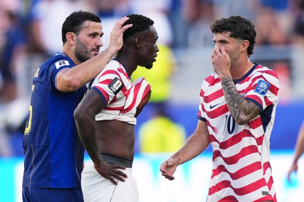 U.S. striker Folarin Balogun (20) gets a pat on the head from Bosnia's Sead Kolasinac (5) and words of encouragement from Christian Pulisic (right) after getting a red card in their World Cup match on Wednesday in Santa Clara. (AP Photo/Martin Meissner)