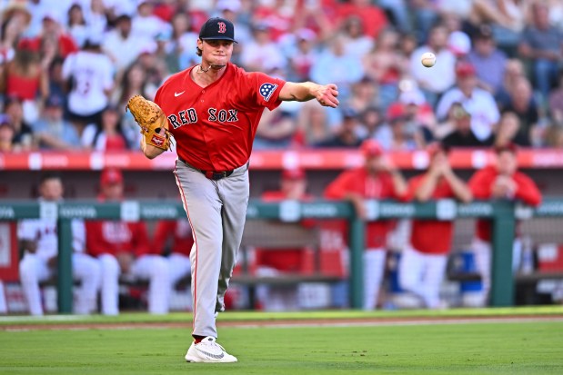 Boston Red Sox pitcher Jake Bennett throws to first base for an out during the first inning of a baseball game against the Los Angeles Angels, Friday, July 3, 2026, in Anaheim, Calif. (AP Photo/William Liang)