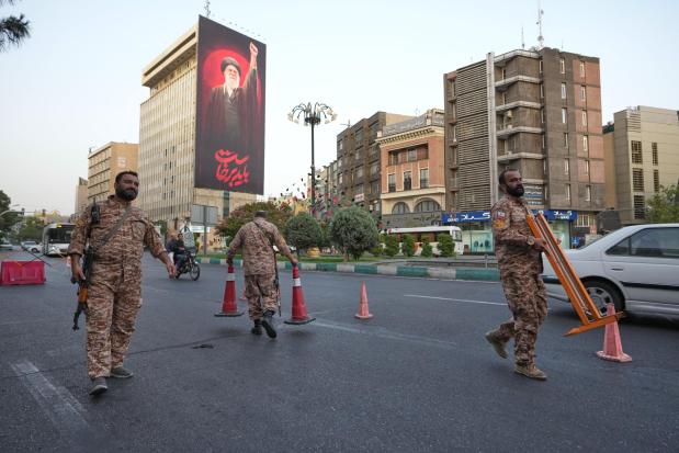 Basij paramilitary forces set up a checkpoint at a square.