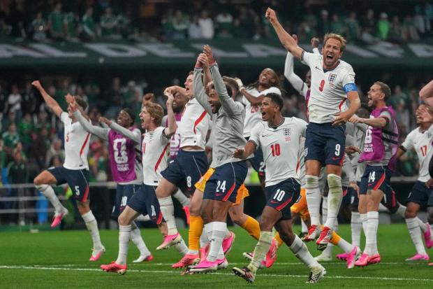 England players celebrate after winning their match against Mexico.