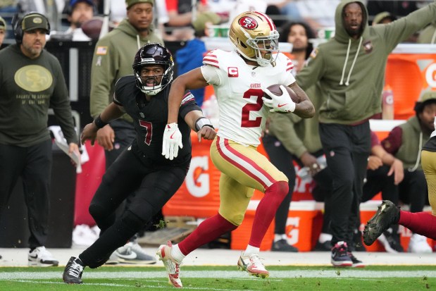 San Francisco 49ers cornerback Deommodore Lenoir (2) returns an interception thrown by Arizona Cardinals quarterback Jacoby Brissett (7) during the second half of an NFL football game in Glendale, Ariz., Sunday, Nov. 16, 2025. (AP Photo/Ross D. Franklin)