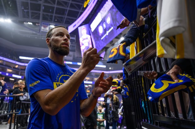 Golden State Warriors' Stephen Curry (30) signs autographs before their NBA game at Golden 1 Center in Sacramento, Calif., on Friday, April 10, 2026. (Jose Carlos Fajardo/Bay Area News Group)
