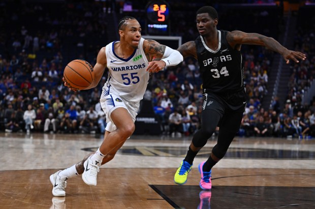 Golden State Warriors' Chance McMillian (55) drives against San Antonio Spurs' Tyon Grant-Foster (34) in the fourth quarter of their California Classic Summer League game at Chase Center in San Francisco, Calif., on Sunday, July 5, 2026. (Jose Carlos Fajardo/Bay Area News Group)