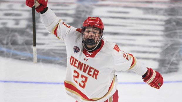 Denver defenseman Eric Pohlkamp (23) celebrates a goal scored during the first period of an NCAA hockey regional game against Cornell, Friday, March 27, 2026, in Loveland, Co. (AP Photo/Tyler Tate)