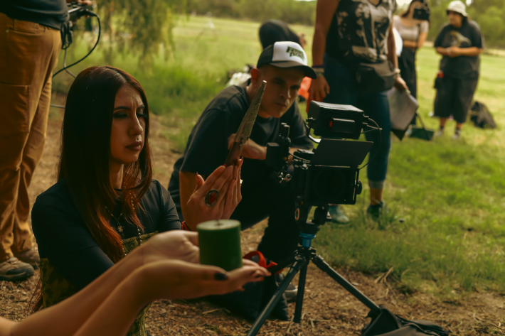 a woman with a candle being filmed