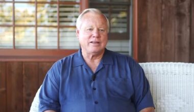 Bill Horn sitting on sofa talking about his military service