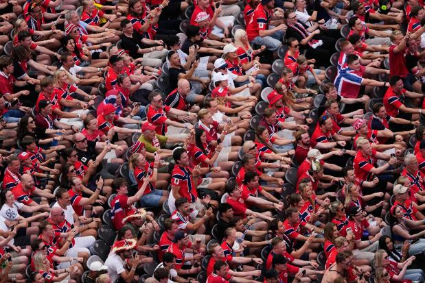Norway fans celebrate with a Viking row chant after their team beat Brazil.