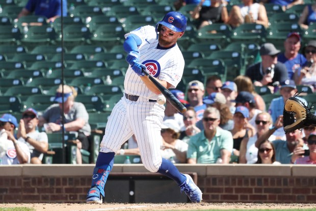 Cubs first baseman Michael Busch hits a single in the eighth inning against the Padres at Wrigley Field on July 1, 2026. (Terrence Antonio James/Chicago Tribune)