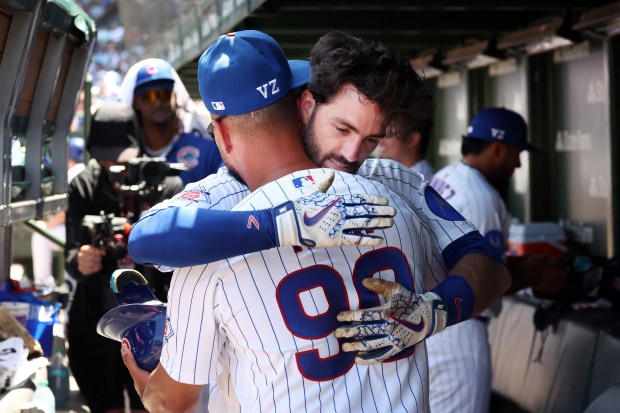 Cubs shortstop Dansby Swanson hugs coach Jonathan Mota (90) after hitting a home run in the third inning against the Padres at Wrigley Field on July 1, 2026. (Terrence Antonio James/Chicago Tribune)