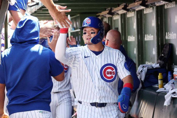 Cubs right fielder Seiya Suzuki (27) celebrates in the dugout after scoring in the third inning against the Padres at Wrigley Field on July 1, 2026. (Terrence Antonio James/Chicago Tribune)