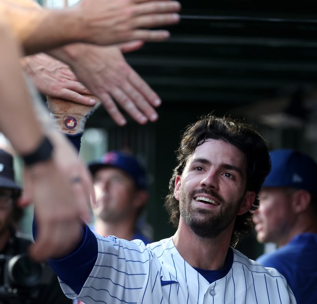 Chicago Cubs shortstop Dansby Swanson (7) is congratulated by his teammates in the dugout after hitting a solo home run in the second inning of a game against the San Diego Padres at Wrigley Field in Chicago on June 30, 2026. (Chris Sweda/Chicago Tribune)