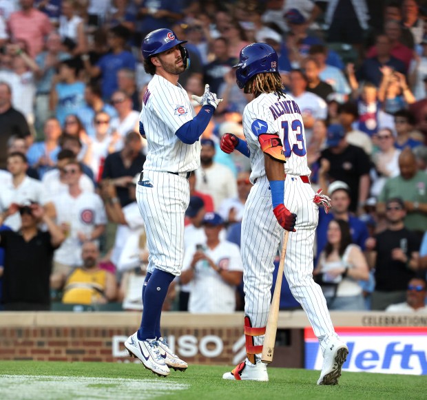Chicago Cubs shortstop Dansby Swanson (left) celebrates with teammate Kevin Alcántara (right) after Swanson hit a solo home run in the second inning of a game against the San Diego Padres at Wrigley Field in Chicago on June 30, 2026. (Chris Sweda/Chicago Tribune)